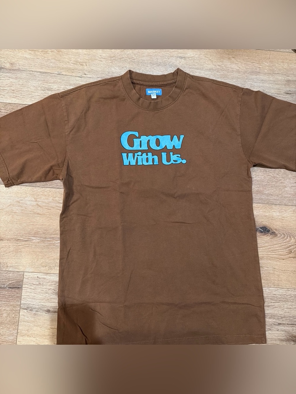 Arket Brown Tee with Bright Blue "Grow With Us" Graphic